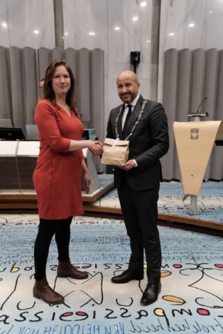 Eva van Esch schudt burgemeester Marcouch de hand.